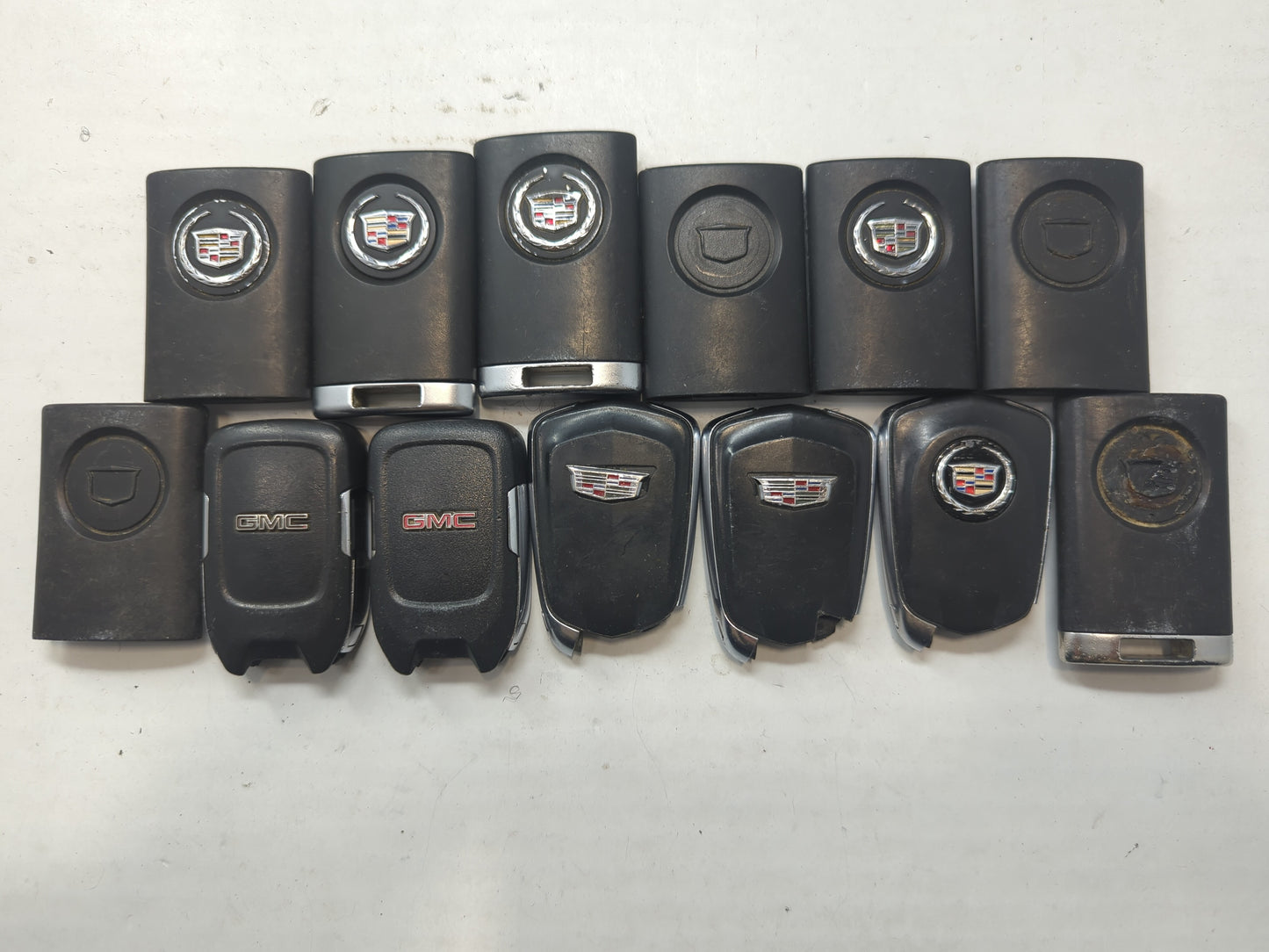 Lot of 13 Cadillac Keyless Entry Remote Fob MIXED FCC IDS MIXED PART - Oemusedautoparts1.com
