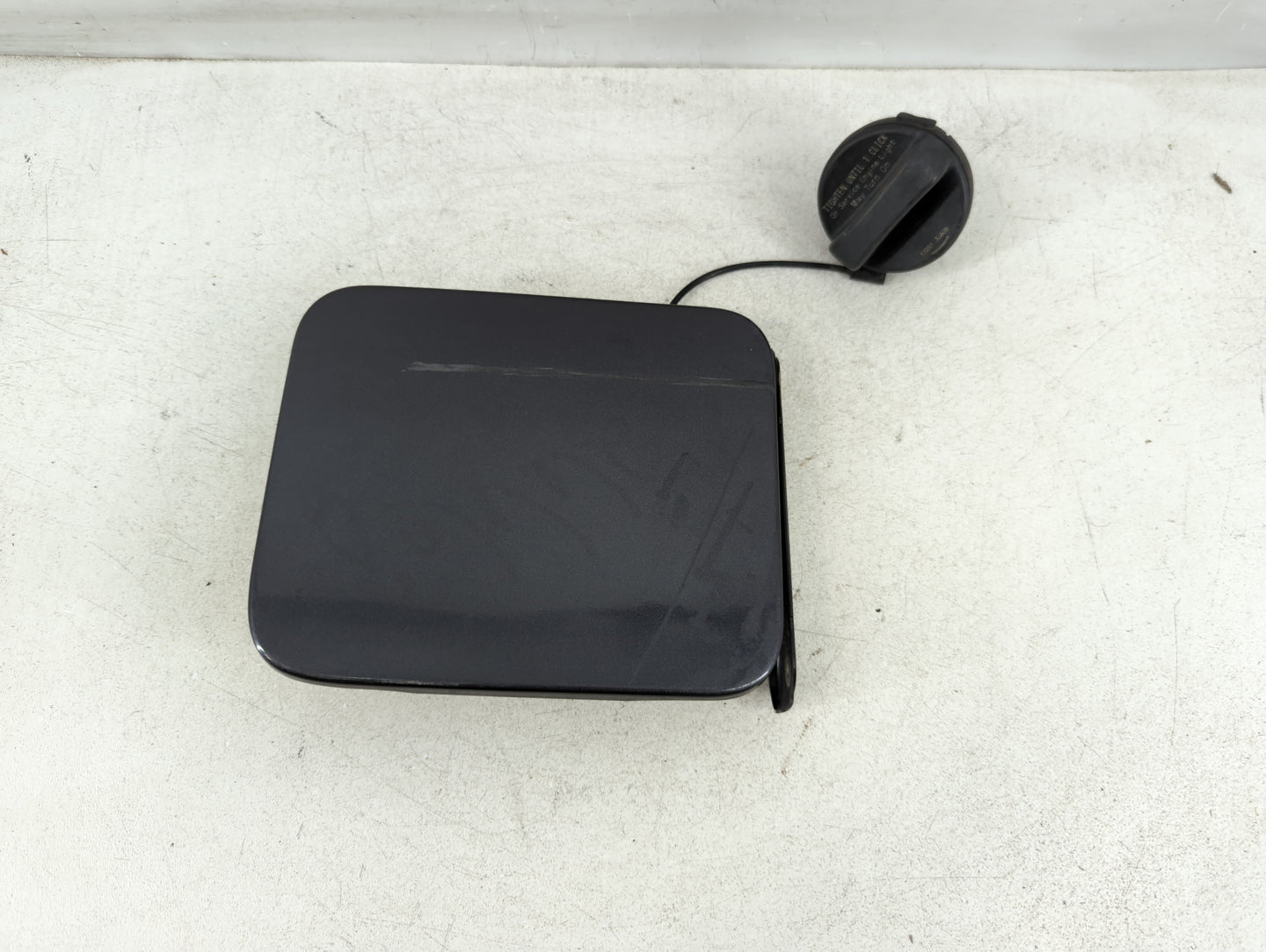 2015 Nissan Versa Fuel Tank Door Lid Gas Tank Black - Oemusedautoparts1.com