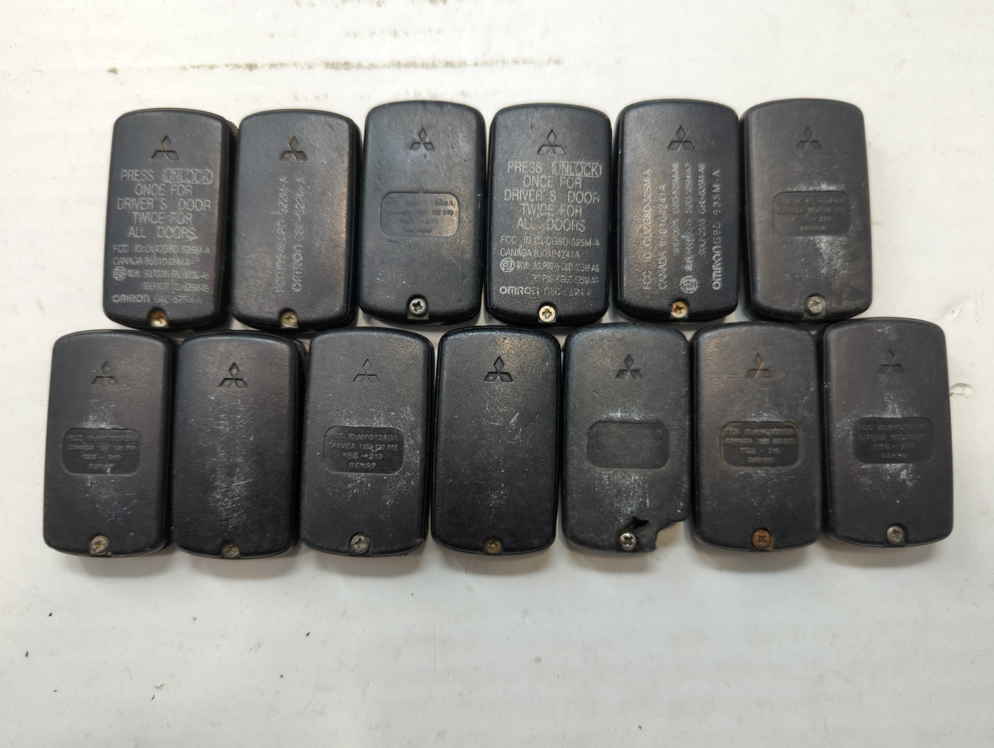Lot of 13 Mitsubishi Keyless Entry Remote Fob MIXED FCC IDS - Oemusedautoparts1.com