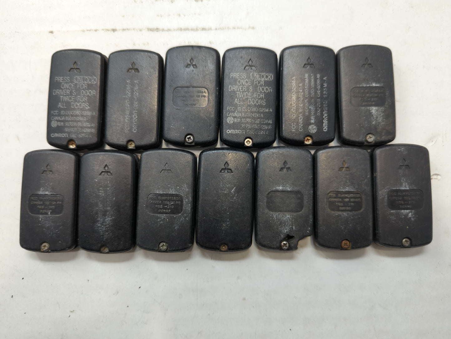 Lot of 13 Mitsubishi Keyless Entry Remote Fob MIXED FCC IDS - Oemusedautoparts1.com